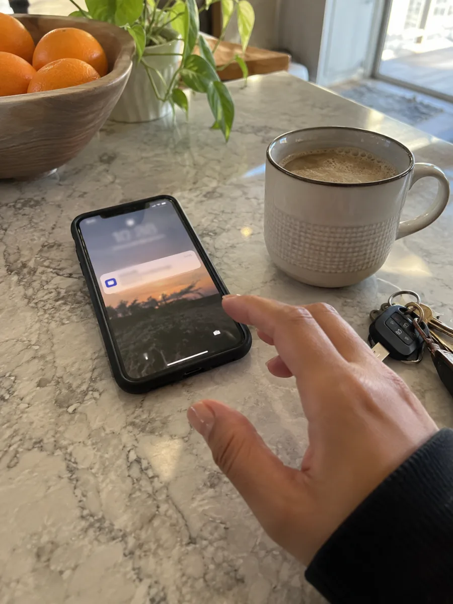 A phone receiving a payment notification on a kitchen counter